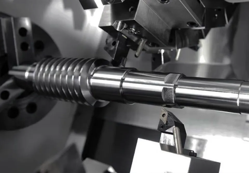 CNC turning centre cutting a threaded steel shaft